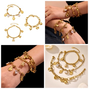 Detail of 18k gold-plated bracelet featuring zircon heart, bow, and bear charms