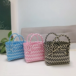 Detailed view of woven hand-woven gift baskets in blue, pink, and black colors