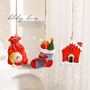 Three-piece set of snowman gift bag, Christmas sock, and snowy house resin ornaments