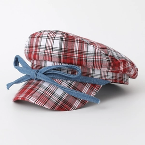 Japanese style red plaid newsboy cap with a denim bow accent on a clean white background