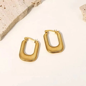 Detailed shot of gold-plated square hoop earrings with textured horizontal stripes