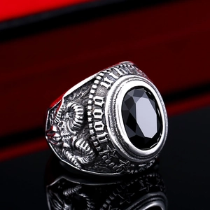 Macro view of vintage stainless steel ring with oval black zircon and ram head carving