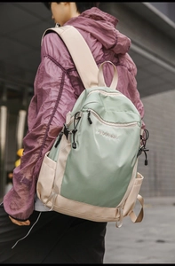 Lifestyle view of green and beige waterproof nylon backpack with BAYORE logo