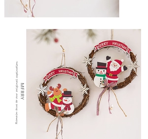 Detail of Christmas rattan wreath featuring Santa Claus and reindeer with a red bow