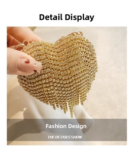 Detailed macro of golden heart clutch with sparkling rhinestones and metal tassels