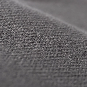 Close-up of high-quality dark grey knitted fabric showing soft texture and premium weave