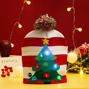 Detail of knitted Christmas hat with LED lights, striped pattern and a fuzzy pom-pom