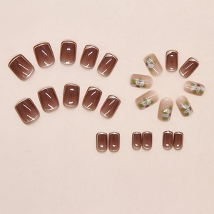 Flat lay of 24pcs press-on nails featuring floral patterns and brown gradient finish