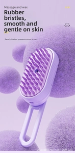 Detail showing the purple pet massage brush with soft rubber bristles and ergonomic handle