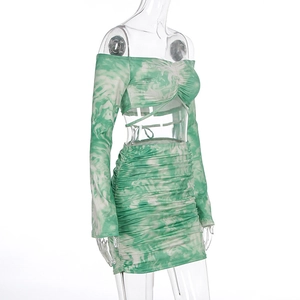 Detail of green and white tie-dye ruched two-piece set featuring crossover belly ties