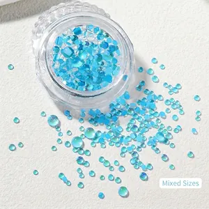 Close-up of mixed size light blue iridescent mermaid glass beads for nail art design
