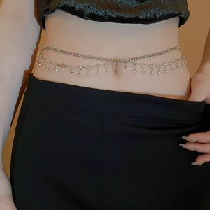 Close-up of double-layer silver body chain featuring sparkling diamond tassels on model
