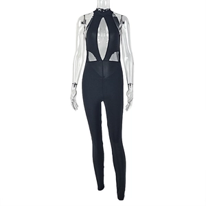 Detailed view of black halter cutout jumpsuit with mesh panels and slim fit design