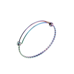 Close-up of rainbow plated stainless steel twisted bangle with adjustable sliding clasp