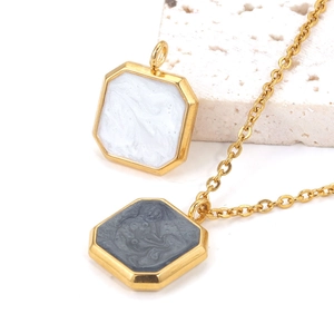 Golden octagonal pendant necklace with white and grey marble resin inlay on white stone
