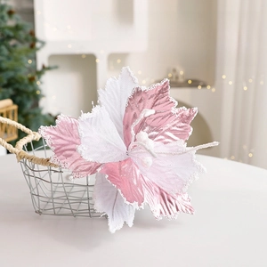 Pink and white Christmas poinsettia flower with glitter beads in a metal basket