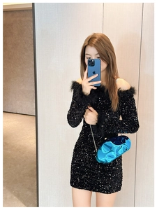 Detail of sequin dress with feather cuffs and blue metallic evening chain bag