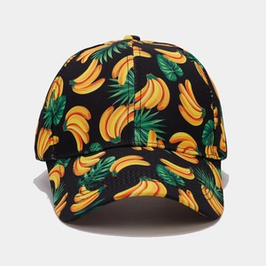 Detailed close-up of vibrant banana and tropical leaf print on a black baseball cap