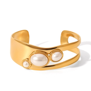 Detail of gold-plated stainless steel cuff featuring three elegant white inset pearls
