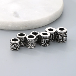 Detailed view of seven vintage stainless steel spacer beads with antique silver finish
