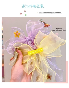 Detail of 5cm organza bow hair clips with central floral accents for girls