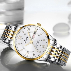 Detail of a business watch featuring a white dial with Roman numerals and steel band