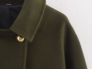 Close-up of wool-blend coat texture featuring elegant double-breasted gold button detail