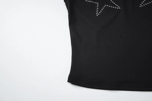 Close-up of black ribbed fabric featuring a sparkling silver rhinestone star pattern