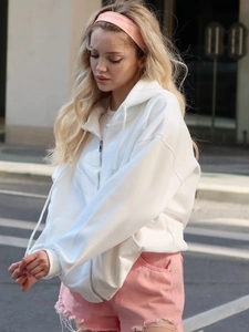 Oversized white zip-up hoodie featuring a loose street style design with hood and drawstrings