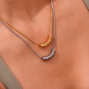 18K gold and silver bean pendant snake chain necklaces set shown on model