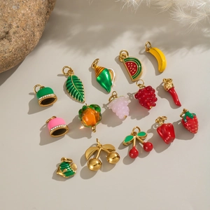 Detailed macro view of colorful 18K gold plated fruit charms with enamel finish