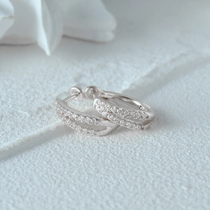 Detailed view of silver S925 huggie earrings with double rows of sparkling crystals