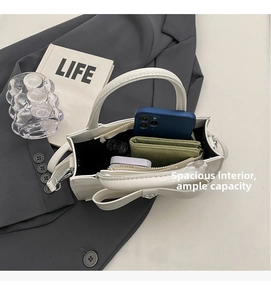 Macro view of the white square handbag showing spacious interior and compartments