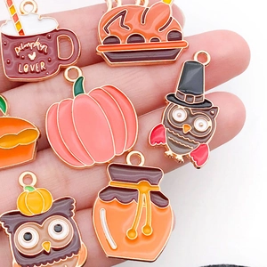 Macro shot of assorted Thanksgiving charms including pumpkin and turkey enamel alloy pendants
