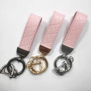 Pink braided leather keychains with black nickel, gold and silver metal hardware details
