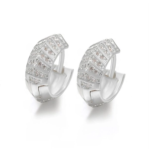Macro detail of silver hoop earrings featuring V-shaped micro-pave zircon inlay