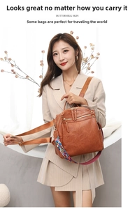 Detail of brown leather backpack with colorful bohemian style woven shoulder strap