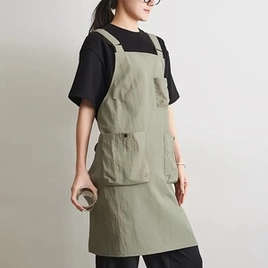 Waterproof light green work apron with adjustable straps and large pockets for kitchen use