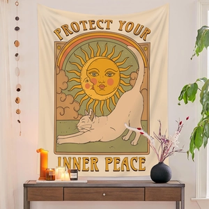 Detail of cat and rainbow tapestry with Protect Your Inner Peace quote on white wall