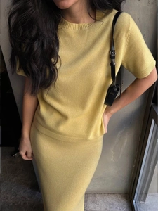 Detailed knit texture of light yellow two-piece skirt set with ribbed cuffs and collar