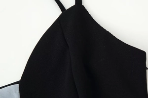 Detail view of durable black fabric texture and fine stitching on the dress shoulder straps