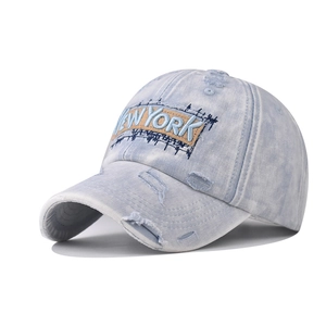 Vintage washed light blue denim baseball cap featuring New York embroidery and distressed rips