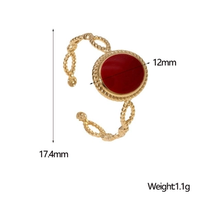 Macro view of a gold-plated vintage open ring with red oval stone and twisted rope design