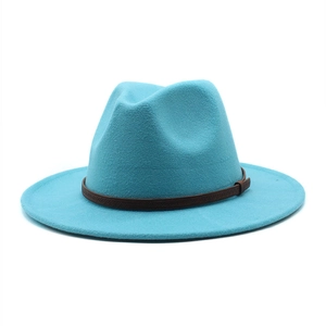 Detailed macro view of lake blue wool fedora hat with brown leather buckle strap