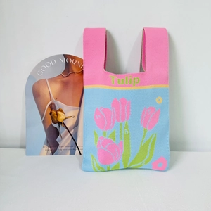 Close-up of knitted tote bag featuring pink and blue patchwork and tulip floral pattern
