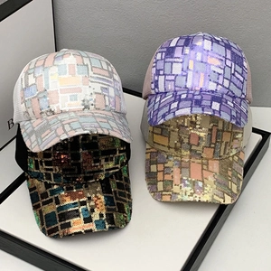 Close-up of four sequined baseball caps with mesh back in various shiny color patterns