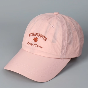 Close-up of pink quick-dry baseball cap featuring detailed lucky clover embroidery