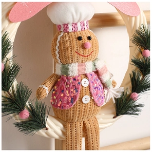 Detail of Christmas gingerbread man wreath with chef hat and striped scarf