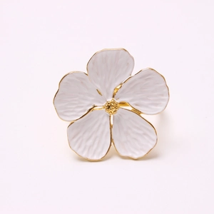 White flower napkin ring with gold edges and petal details on white background