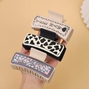 Set of three western style hair claws with cow print, sunflower and Yee Haw pattern